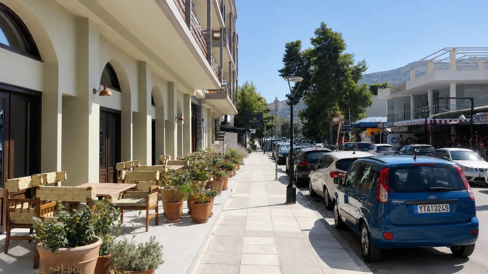 Hotel sidewalk and outdoor seating in Tolo